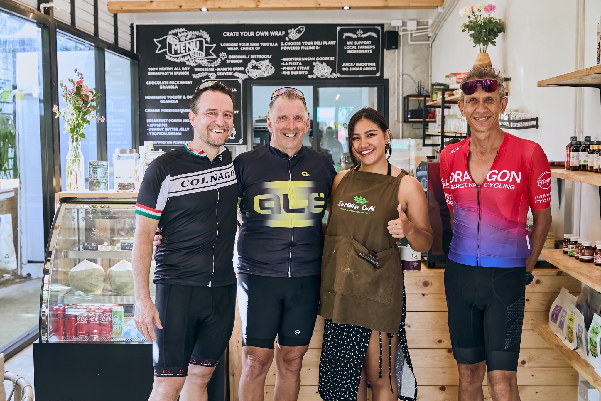 Guests posing with café staff at the counter