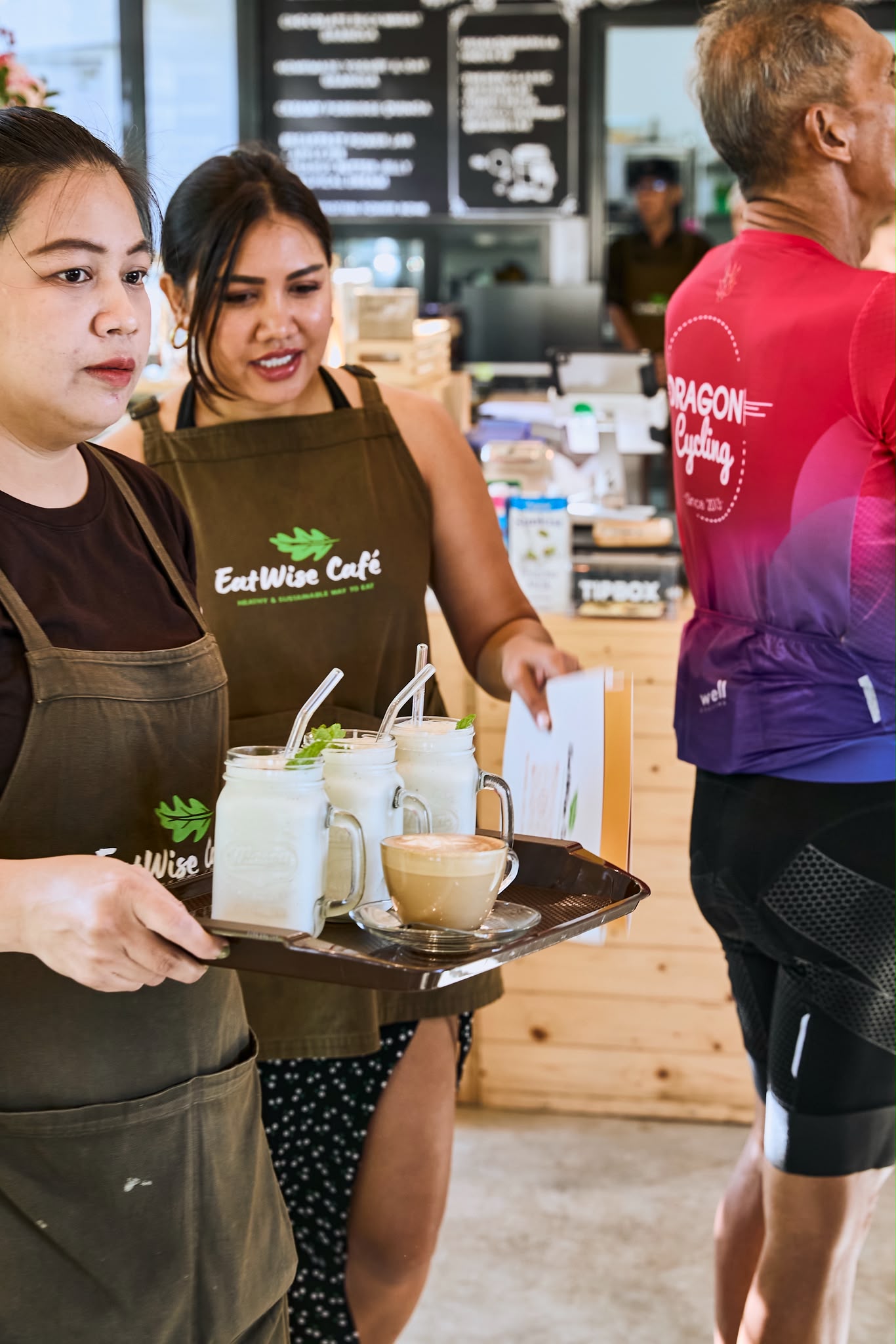 EatWise staff serving smoothies and coffee to a visiting group